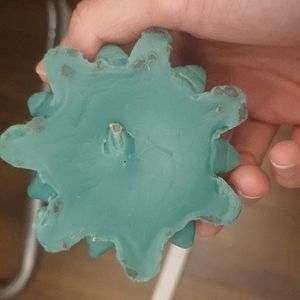 Scented candle shaped like a multi-petaled flower